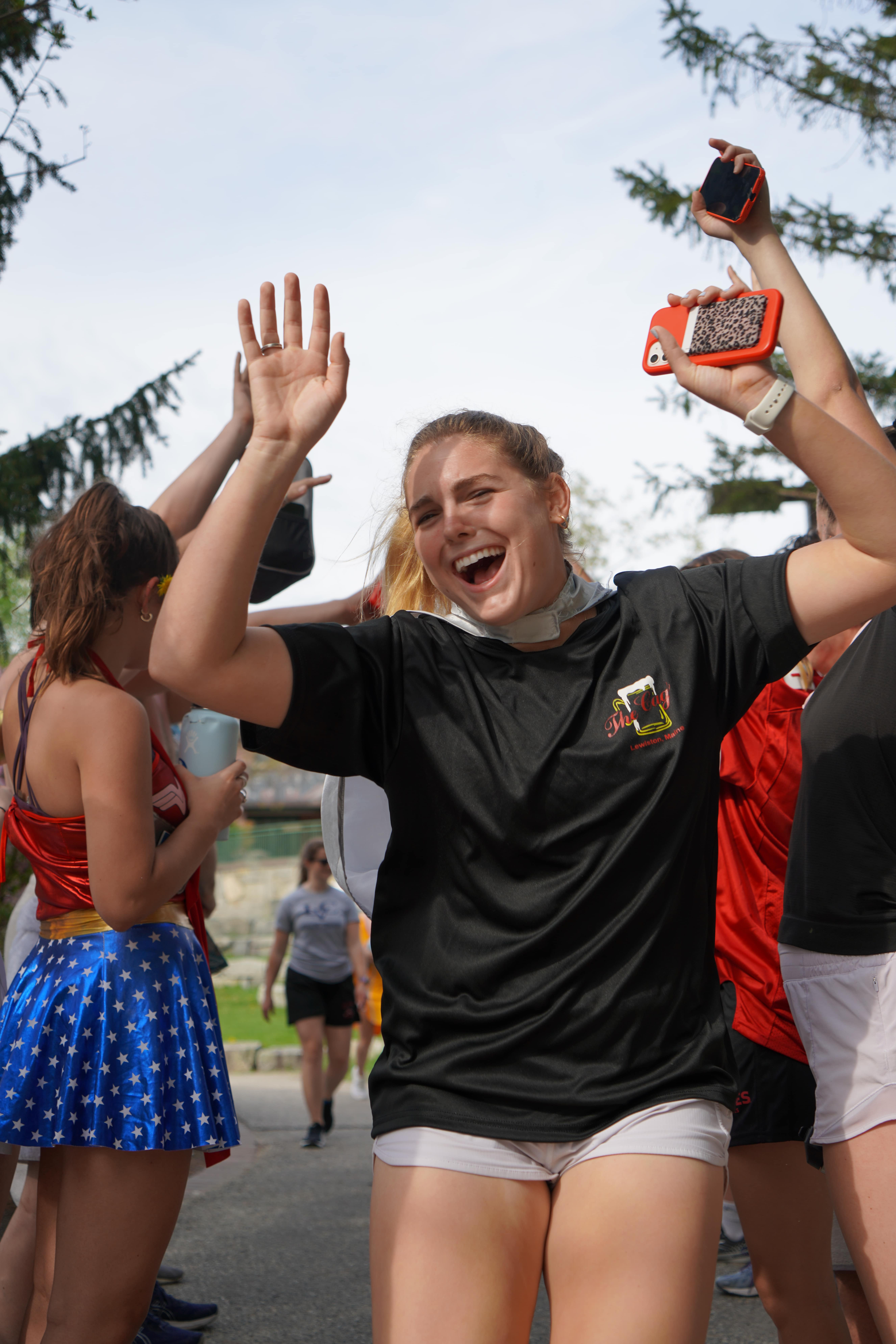 young woman smiling with her hands in the air